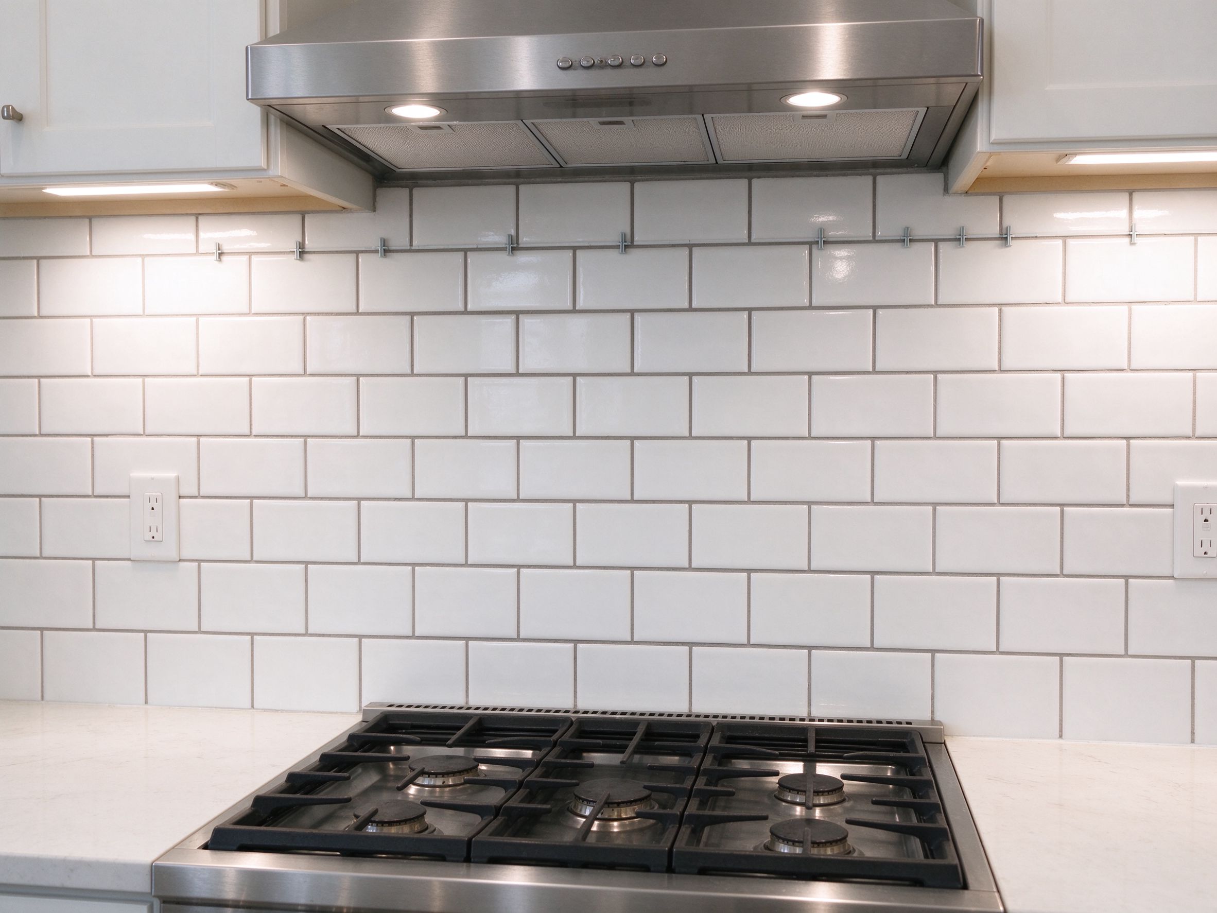White subway tiles installed as a kitchen backsplash